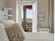Balcony view showcasing a wide-open landscape and an open door to the main bedroom at 14025 Florence Ct, Brighton, CO 80602
