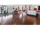 Spacious basement featuring gym equipment, a wet bar, and finished hardwood floors, perfect for entertaining guests at 14025 Florence Ct, Brighton, CO 80602
