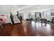 Finished basement with gym equipment, a decorative stairwell, and elegant hardwood floors, creating versatile space at 14025 Florence Ct, Brighton, CO 80602