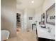 Bathroom view showing storage, a walk-in closet, vanity, and tile flooring at 14025 Florence Ct, Brighton, CO 80602
