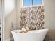 Close up on bathtub area, highlighting the modern tile details and luxurious fixtures at 14025 Florence Ct, Brighton, CO 80602