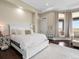 Bright bedroom with plush white bedding and floor to ceiling windows at 14025 Florence Ct, Brighton, CO 80602
