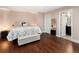 Cozy bedroom with dark wood floors, ensuite bath, and modern furnishings at 14025 Florence Ct, Brighton, CO 80602