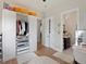 Open white closet interior featuring drawers, custom shelves, and hardwood flooring at 14025 Florence Ct, Brighton, CO 80602
