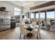 Dining area featuring a glass table, modern chairs, and large windows with views to the outdoors at 14025 Florence Ct, Brighton, CO 80602