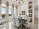 Bright dining room featuring modern chandelier, decor shelving, and large windows at 14025 Florence Ct, Brighton, CO 80602