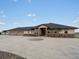 Expansive ranch home featuring stone accents and a large circular driveway for ample parking at 14025 Florence Ct, Brighton, CO 80602
