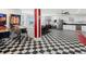 The expansive kitchen has a black and white checkered floor, stainless steel appliances, and retro diner decor at 14025 Florence Ct, Brighton, CO 80602