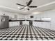 The expansive kitchen has a black and white checkered floor, stainless steel appliances, and white cabinets at 14025 Florence Ct, Brighton, CO 80602