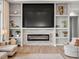 Comfortable living room featuring a fireplace, built-ins, and decor at 14025 Florence Ct, Brighton, CO 80602