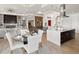 Open living space merges dining and kitchen areas with an abundance of natural light and scenic outdoor views at 14025 Florence Ct, Brighton, CO 80602
