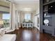 Relaxing main bedroom area featuring hardwood floors, neutral paint, and a modern entertainment center at 14025 Florence Ct, Brighton, CO 80602