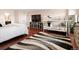 Spacious main bedroom with hardwood floors, a large window, a bunkbed, and a stylish area rug at 14025 Florence Ct, Brighton, CO 80602