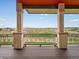 Picturesque views from this covered patio with decorative columns at 14025 Florence Ct, Brighton, CO 80602