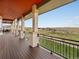 Stunning view from the covered patio with a black iron railing at 14025 Florence Ct, Brighton, CO 80602