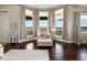 Bright sitting area featuring an armchair, large windows, and sleek design at 14025 Florence Ct, Brighton, CO 80602