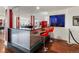 Retro-style wet bar with red barstools and eye-catching design, great for creating a unique entertainment space at 14025 Florence Ct, Brighton, CO 80602