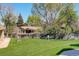 Spacious backyard with lush green grass and mature trees at 12486 W Nevada Pl # 106, Lakewood, CO 80228