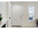 Bright entryway featuring a crisp white door, neutral walls, and a window providing natural light at 12486 W Nevada Pl # 106, Lakewood, CO 80228