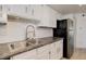 Updated kitchen with stainless steel sink and faucet, tile backsplash and modern appliances at 12486 W Nevada Pl # 106, Lakewood, CO 80228