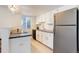 Modern kitchen features stainless steel appliances, white cabinets, and sleek countertops at 12486 W Nevada Pl # 106, Lakewood, CO 80228