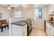 Bright kitchen with modern appliances, sleek countertops, and a view into the living room at 12486 W Nevada Pl # 106, Lakewood, CO 80228