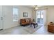 Bright living room featuring a comfortable sofa, a large window, and a view of the neighborhood at 12486 W Nevada Pl # 106, Lakewood, CO 80228