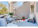 Outdoor patio with glass-topped table, wicker chairs, and a charming space for relaxation at 12486 W Nevada Pl # 106, Lakewood, CO 80228