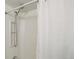 Clean shower showcasing a detachable shower head, built-in shelving, and a bright white shower curtain at 12486 W Nevada Pl # 106, Lakewood, CO 80228