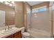 Bathroom with white tiled shower-tub and updated vanity sink at 3873 Fairbrook Pt, Highlands Ranch, CO 80130