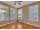Bright bedroom featuring wood floors, neutral paint, and large windows letting in ample natural light at 3873 Fairbrook Pt, Highlands Ranch, CO 80130