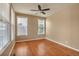 Neutral bedroom with hardwood flooring, a ceiling fan, and two windows for lots of natural light at 3873 Fairbrook Pt, Highlands Ranch, CO 80130