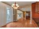 Well-lit kitchen features wood floors, stone details, and a view into the living room with fireplace at 3873 Fairbrook Pt, Highlands Ranch, CO 80130