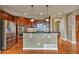 Spacious kitchen features a large island, stainless steel appliances, and dark cabinetry at 3873 Fairbrook Pt, Highlands Ranch, CO 80130