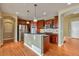 Open kitchen with stainless appliances, dark cabinetry, and eat-in island at 3873 Fairbrook Pt, Highlands Ranch, CO 80130