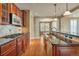 Stylish kitchen featuring granite counters, stainless appliances, a gas range, and dark wood cabinets at 3873 Fairbrook Pt, Highlands Ranch, CO 80130