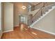 Spacious home living room with hardwood floors, a staircase, and modern chandelier at 3873 Fairbrook Pt, Highlands Ranch, CO 80130