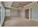 Neutral living room offering natural light, carpeting, and a ceiling fan at 3873 Fairbrook Pt, Highlands Ranch, CO 80130