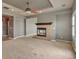Inviting living room featuring a cozy fireplace and neutral carpeting at 3873 Fairbrook Pt, Highlands Ranch, CO 80130