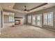 Spacious living room with a ceiling fan, a cozy fireplace, and ample natural light at 3873 Fairbrook Pt, Highlands Ranch, CO 80130