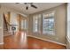 Bright and open living room with a staircase, fireplace, hardwood flooring, and natural light at 3873 Fairbrook Pt, Highlands Ranch, CO 80130