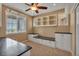 Home office featuring a built-in desk, cabinets, and a ceiling fan at 3873 Fairbrook Pt, Highlands Ranch, CO 80130