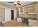 Office space featuring built-in shelving and cabinets for storage and organization at 3873 Fairbrook Pt, Highlands Ranch, CO 80130