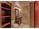 Stylish powder room features a dark wood vanity and decorative mirror at 3873 Fairbrook Pt, Highlands Ranch, CO 80130