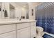 Bathroom with tile floor, shower with blue curtain, and vanity with ample cabinet space at 17423 Cornerstone Ln, Parker, CO 80134