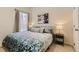 Well-lit bedroom with a queen bed with carpet and a painting at 17423 Cornerstone Ln, Parker, CO 80134