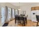 A dining room with hardwood floors features a table, chairs, and windows for natural light at 17423 Cornerstone Ln, Parker, CO 80134