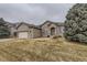 View of a well-maintained home with a lawn and mature trees in a suburban setting at 17423 Cornerstone Ln, Parker, CO 80134
