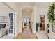 Bright foyer showcasing hardwood floors, elegant archways, and an open floor plan at 17423 Cornerstone Ln, Parker, CO 80134