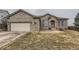 Charming brick home featuring an attached garage and manicured front yard in a quiet neighborhood at 17423 Cornerstone Ln, Parker, CO 80134